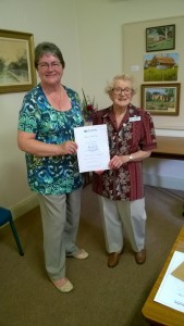Beryl Merrick receives her Mothers' Union 50 year badge and certificate.